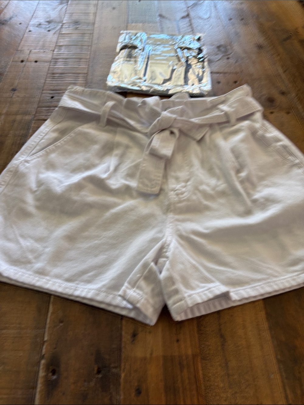 KanCan White Tie-Waist Bermuda Shorts with black tank top.